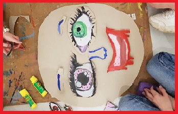 obrazek przedstawia papierową twarz z wyklejonymi oczami, nosem, ustami z papieru